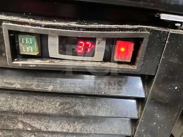 Digital display of Supera G1M-16-B-1 refrigerator showing 37°F temperature, indicating operational status.