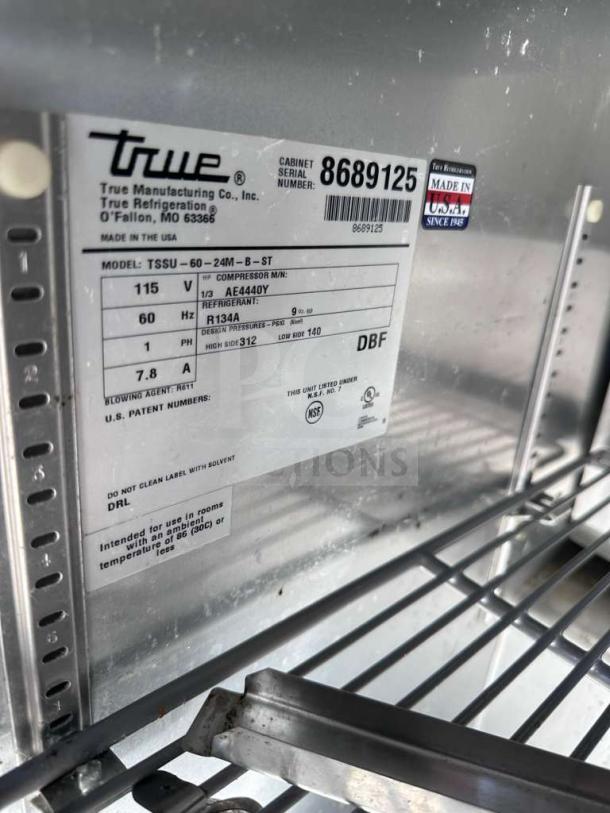 True TSSU-60-24M-B-ST-HC sandwich prep table, 60-inch, stainless steel, two-door, tested, made in USA label visible.