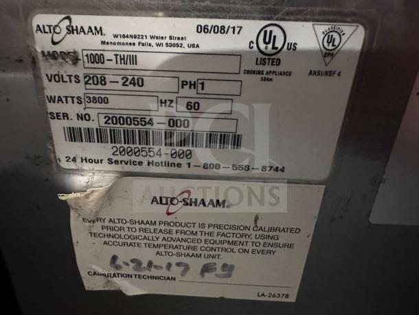 Alto-Shaam 1000-TH/II label showing model, voltage (208-240V), and serial number 2000554-000. Fully tested commercial oven.