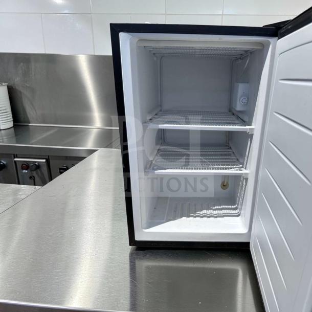 Magic Chef MCUF3S2 3 Cu. Ft. compact upright refrigerator in excellent condition, stainless steel, space-saving design.