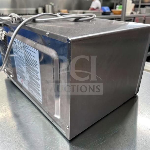 Amana RMS10DSA commercial microwave, 1000W, stainless steel, dial controls, excellent condition, 120V, side view.