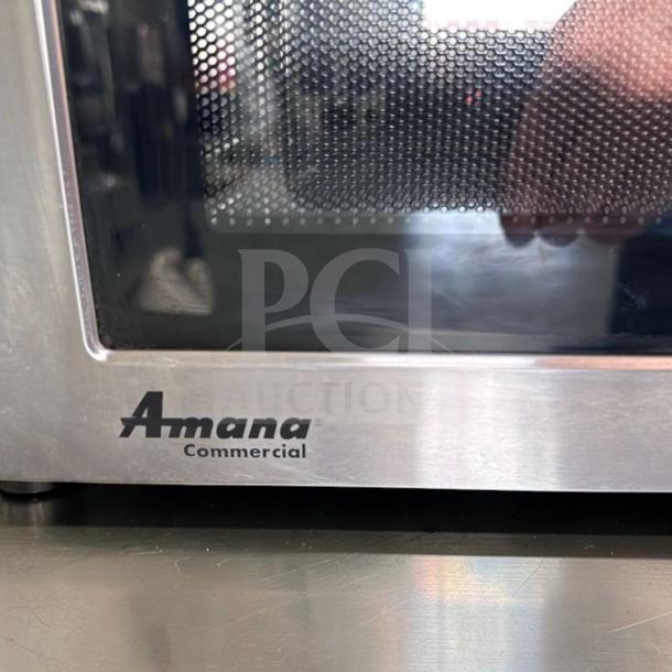 Amana RMS10DSA commercial microwave oven, 1000W, stainless steel, dial controls, excellent condition, logo visible.