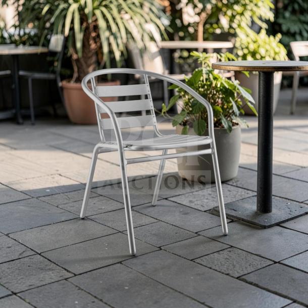 Silver Lancaster Table & Seating outdoor arm chair, powder-coated steel, stackable, commercial grade, excellent condition.