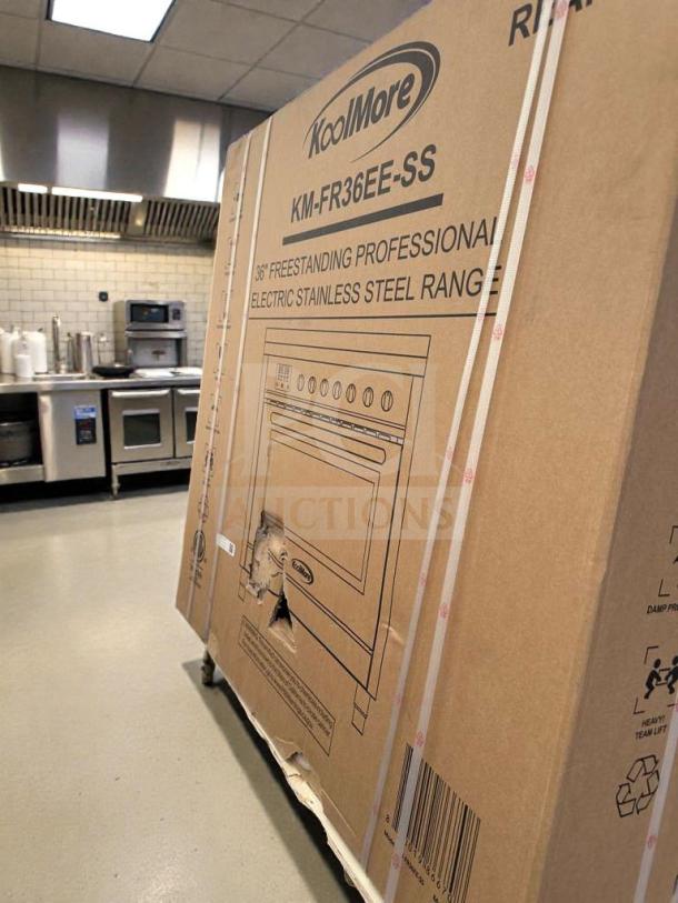 KoolMore 36" electric range in box, model KM-FR36EE-SS. Scratch & dent condition visible on packaging.