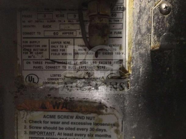 Metal panel inside BKI Commercial Pressure Fryer showing safety and wiring instructions. Labels detail electrical specs and maintenance.