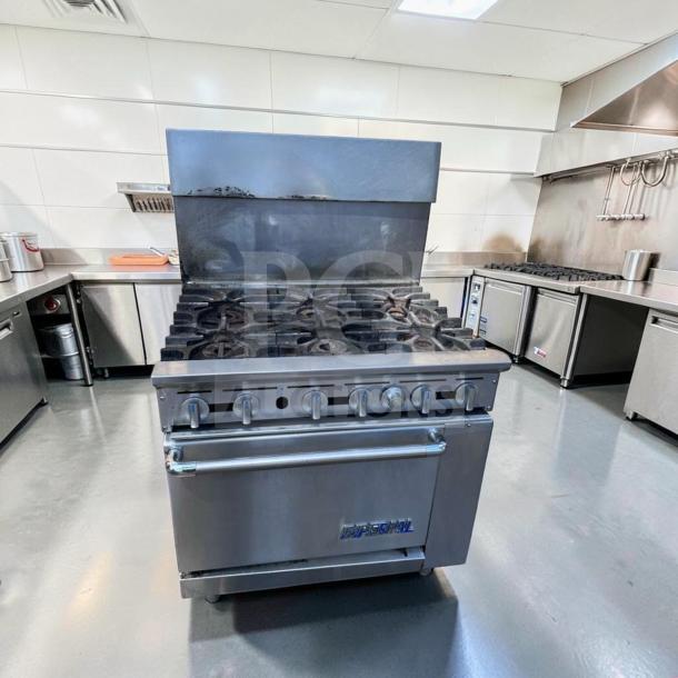Imperial IR-6 36" commercial gas range with 6 burners, oven, and backsplash in excellent condition, made in USA.
