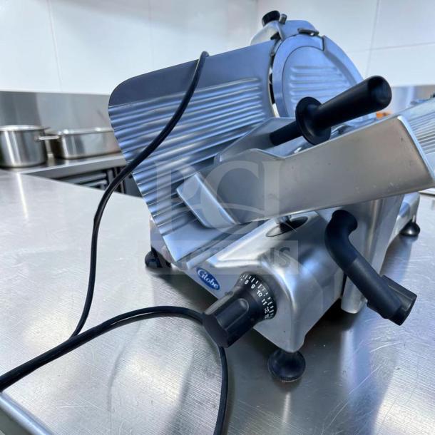 Globe G12 meat slicer, 12" blade, commercial, 1/2 HP, heavy-duty gravity feed, excellent condition, tested, Globe logo visible.