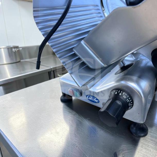 Globe G12 meat slicer, commercial-grade, 12-inch, 1/2 HP, gravity feed, fully tested, excellent condition.