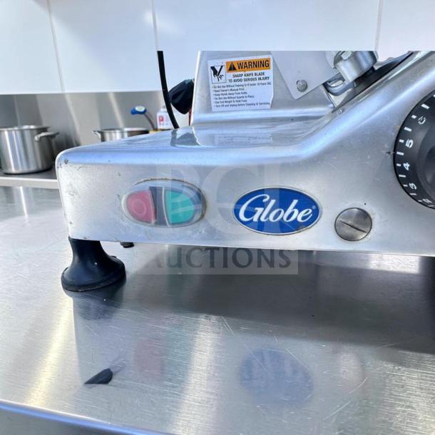 Globe G12 12" Commercial Meat Slicer, Elite Condition, 1/2 HP, Gravity Feed. Visible warning label and control buttons.