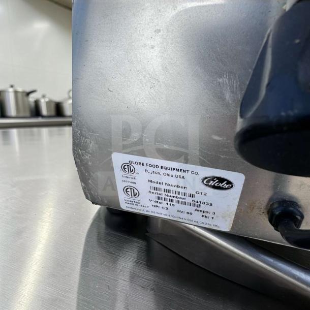Globe G12 12" commercial manual meat slicer, elite condition. Features a 1/2 HP motor, ETL-certified, fully tested.