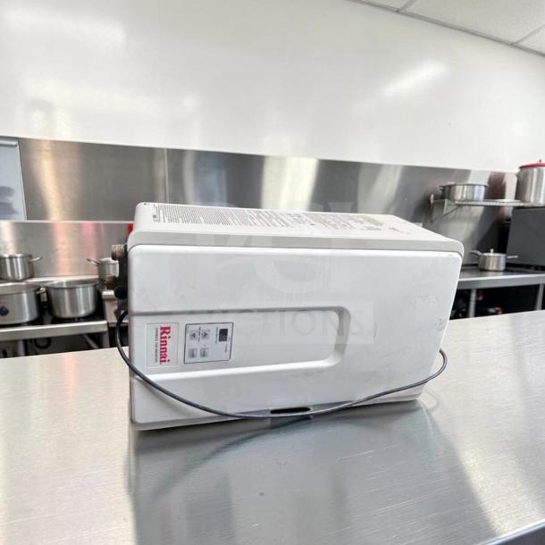 Rinnai V75iN tankless water heater, 7.5 GPM, 180,000 BTU, natural gas, indoor use, excellent condition, model label visible.