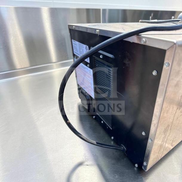 Amana MDC182 Menumaster commercial microwave back view, excellent condition, 1800W, 208-240V, fully operational, with visible label and electric cord.