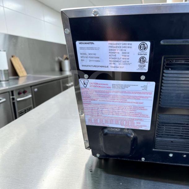 Amana MDC182 Menumaster commercial microwave oven, 1800W, 208-240V, in excellent condition. Labels show specs and safety warnings.