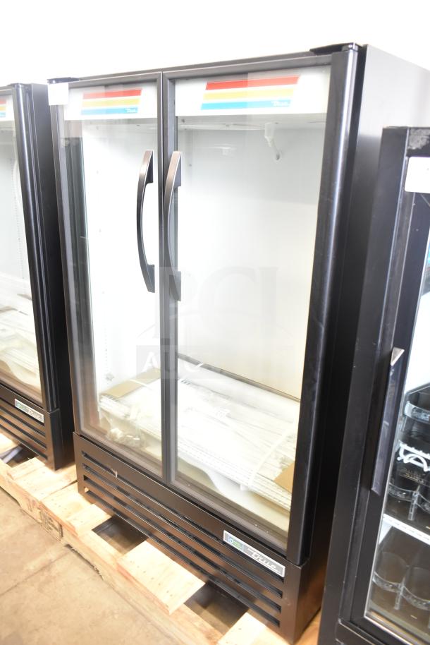 Brand new True TVM-36SL-HC commercial 2-door reach-in cooler merchandiser, 115V, 1 phase, minor dents, handles shown.
