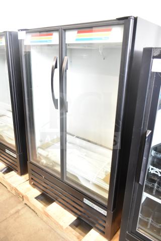 Brand new True TVM-36SL-HC commercial 2-door reach-in cooler merchandiser, 115V, 1 phase, minor dents, handles shown.