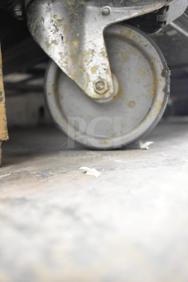 Worn caster wheel of a Desmon GBF-15+ETL commercial blast chiller.