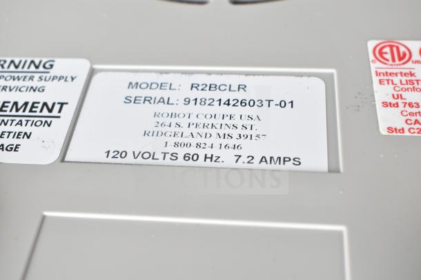 Brand new Robot Coupe R2BCLR food processor label showing model and serial number, 120 volts, 1 hp, scratch and dent condition.