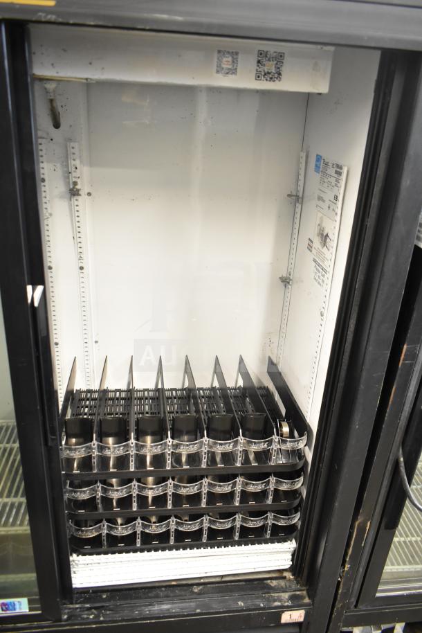 True GDM-41SL-60-LD cooler merchandiser, 2-door, reach-in, 115V, in used condition with visible internal shelving.