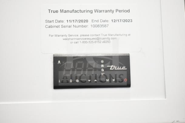 True TSCI-600R-G-PH cooler display panel showing control buttons. Warranty info: Start 11/17/2020, End 12/17/2023. Serial 10083587.
