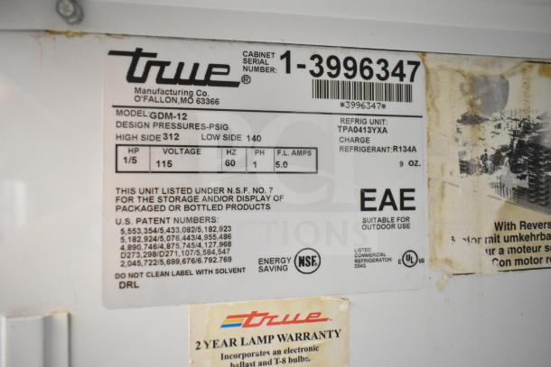 True GDM-12 Cooler Merchandiser label showing model, voltage, and refrigerant details; 115 volts, 1 phase.