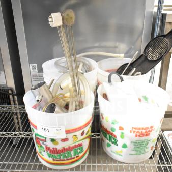 92 ice cream machine parts including scrapers, hoses, seals, knobs in buckets. Mixed materials and conditions. Item tag visible.