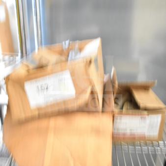 Blurry image of three cardboard boxes on a metal shelf, possibly containing 646-CG5 CPVC x MIP fittings or ice cream machine barrel scrapers.