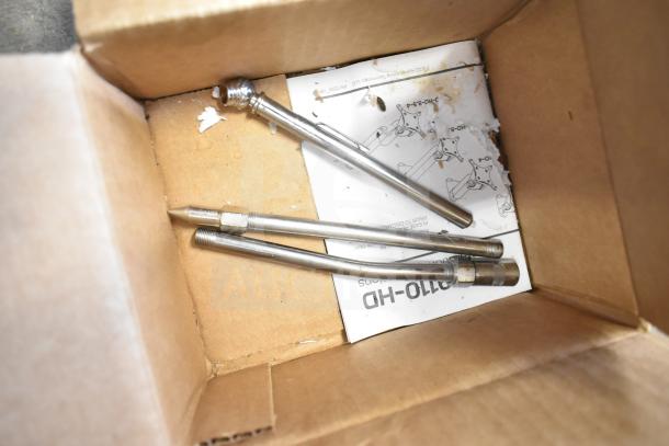 Metal gauge pipes in a cardboard box, three pieces with threaded ends, instructions partially visible, fair condition.