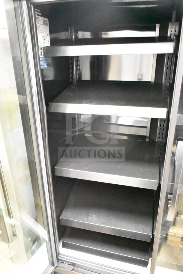 2025 True TVM-48SL-HC commercial cooler, two-door, reach-in design, adjustable shelves, 115V, model label visible.