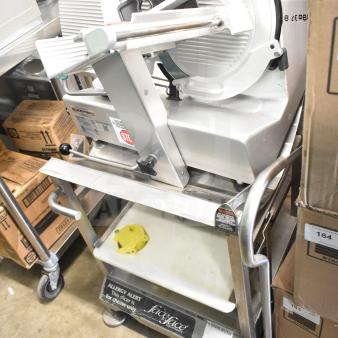 Bizerba GSP H commercial meat slicer on Face to Face stand with visible labels, in good condition, 185 tag on slicer.