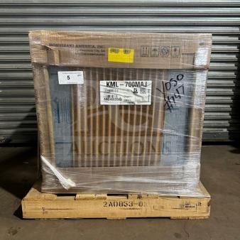 Brand new Hoshizaki KML-700MAJ ice machine in box, air-cooled, crescent cube style. Model and serial number visible.