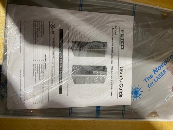 Brand new Fetco HWB-2110 hot water dispenser, 10-gallon capacity, 1-phase, includes user guide, in original packaging.
