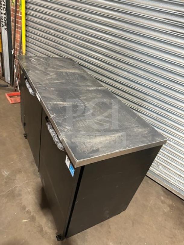 Turbo Air TBB2460SBDN6 bar back cooler, new condition, 2 solid doors, 120V, 1-phase, on casters, black finish.