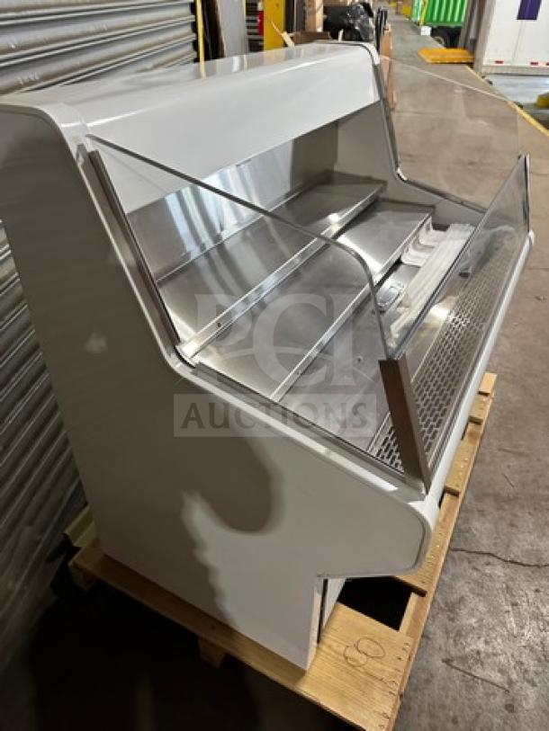 True THAC48LD refrigerated merchandiser, new in box, low-profile design, clear curved display, 115V, model and serial labels visible.