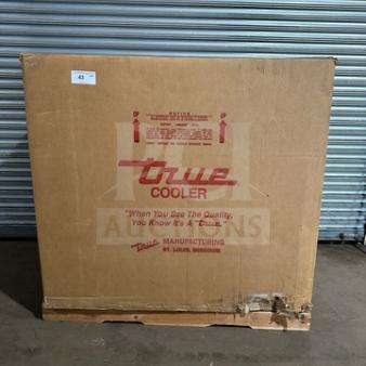 Brand new True THAC48LD refrigerated merchandiser in sealed box. Model and serial number visible. 115V, 1 phase.