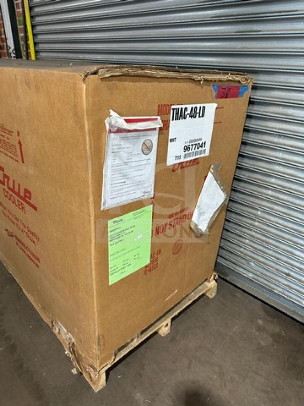 Brand new True THAC48LD refrigerated merchandiser in box, serial 9677041, 115V 1 phase, with visible shipping labels.