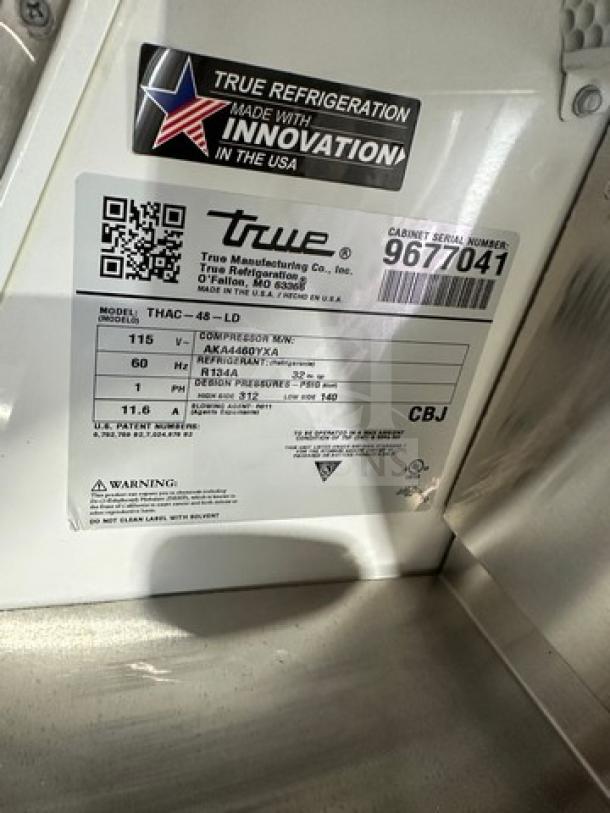 Brand new True THAC48LD refrigerated merchandiser, 115V, 1 phase, serial 9677041, "Made in USA" label, pristine condition.