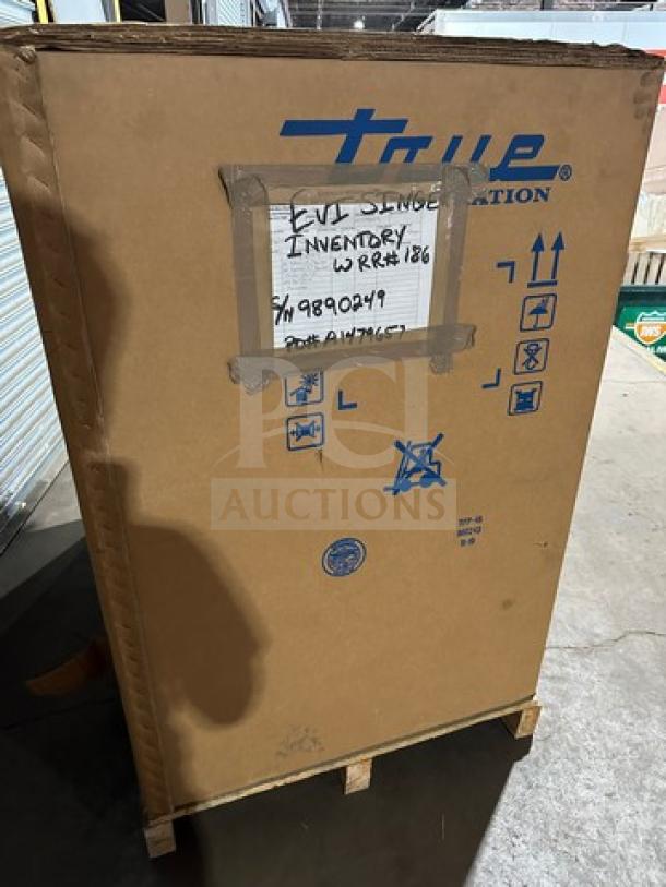 New True TFP48-18MD Refrigerated Sandwich Prep Table in box on casters, Model 115V, Serial 9890249, box labeled with shipping details.