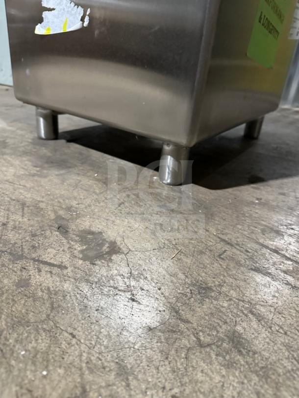 Brand new NBR stainless steel prep sink, model 182414, with legs and strainer, shown in close-up on a concrete floor.