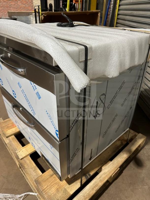 Brand new Continental SW32N 2-drawer refrigerated lowboy/worktop cooler, wrapped in packaging, on a wooden pallet.