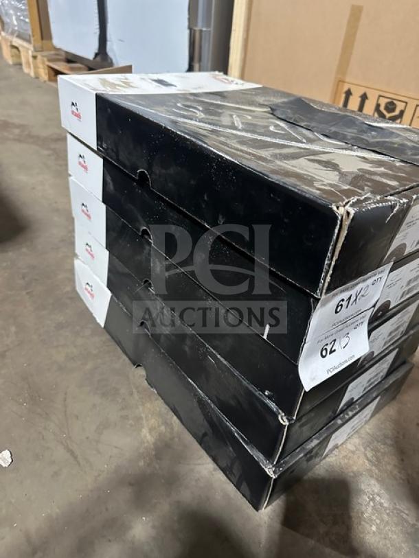 Stack of boxed skillets on a warehouse floor, boxes marked with item codes and identifiable brand logo.