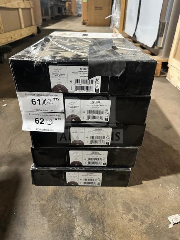 Stack of five skillet boxes with shipping labels. Labels indicate model 1212823, 61x2 quantity, and 62x3 quantity.