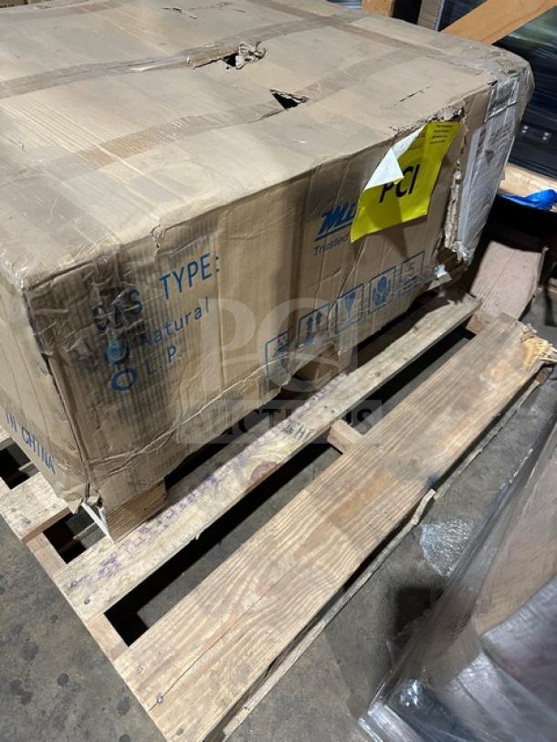 Cardboard box labeled "Natural LP" on wooden pallet, marked "PCI". Box shows wear and damage, indicating contents may need inspection.