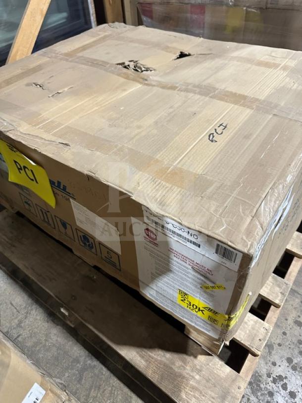 Damaged cardboard box on pallet labeled "Imperial." Signs of wear and handling. Markings and labels visible, indicating caution and handling instructions.