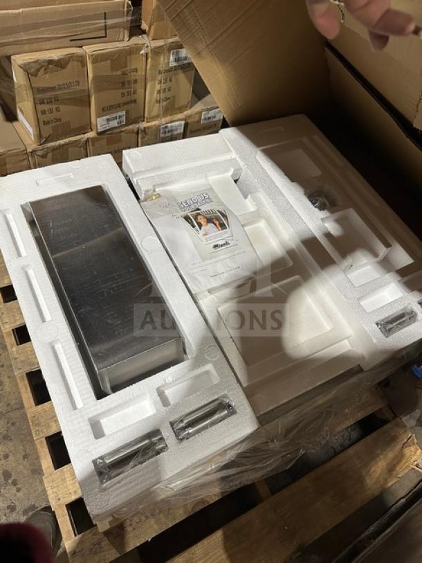 Stainless steel Imperial kitchen equipment in original packaging on a pallet, includes manual. New and unused condition.
