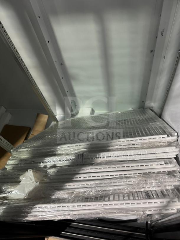 Beverage Air shelving units stacked, wrapped in plastic. New condition, designed for commercial refrigeration use.