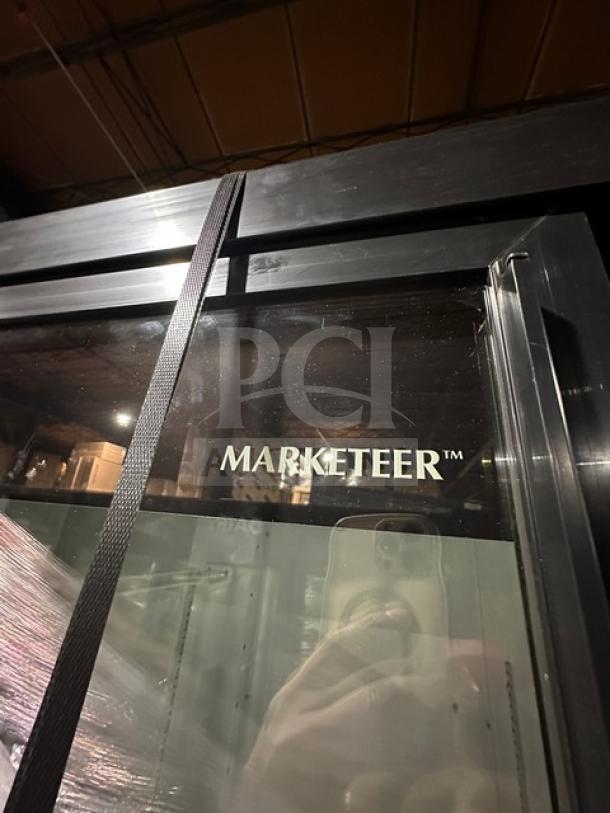 Beverage Air Marketeer commercial display cooler, black frame, glass door, visible wear, ideal for retail beverage storage.