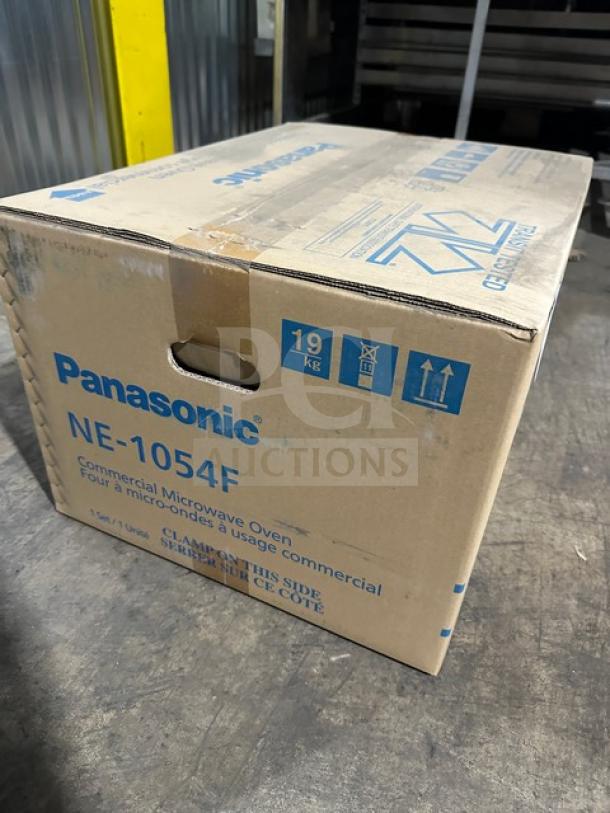 New Panasonic NE1054 commercial microwave in original box with model and voltage details. Digital touch pad feature.