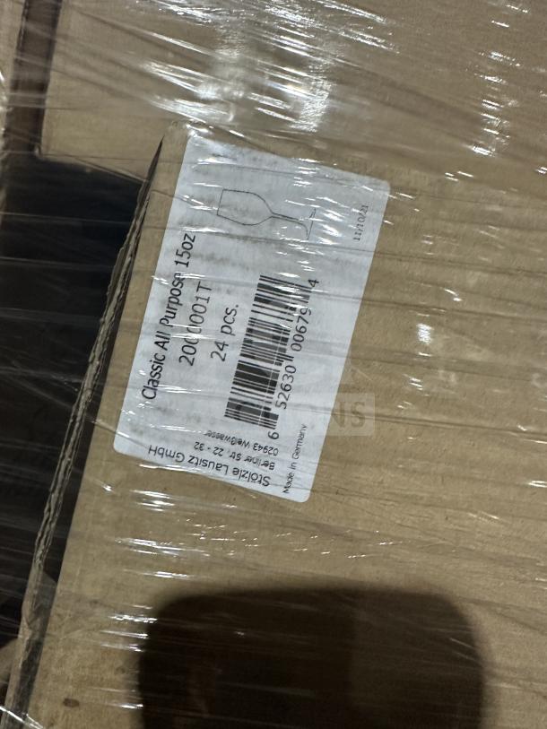 Mixed pallet wrapped in plastic showing a box labeled "Classic All Purpose 15 OZ 200000IT" containing 24 pieces.