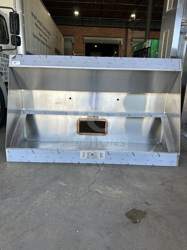 NEW Captive Air 72" stainless steel exhaust hood. Includes mounting holes and a central ventilation opening. Unused condition.