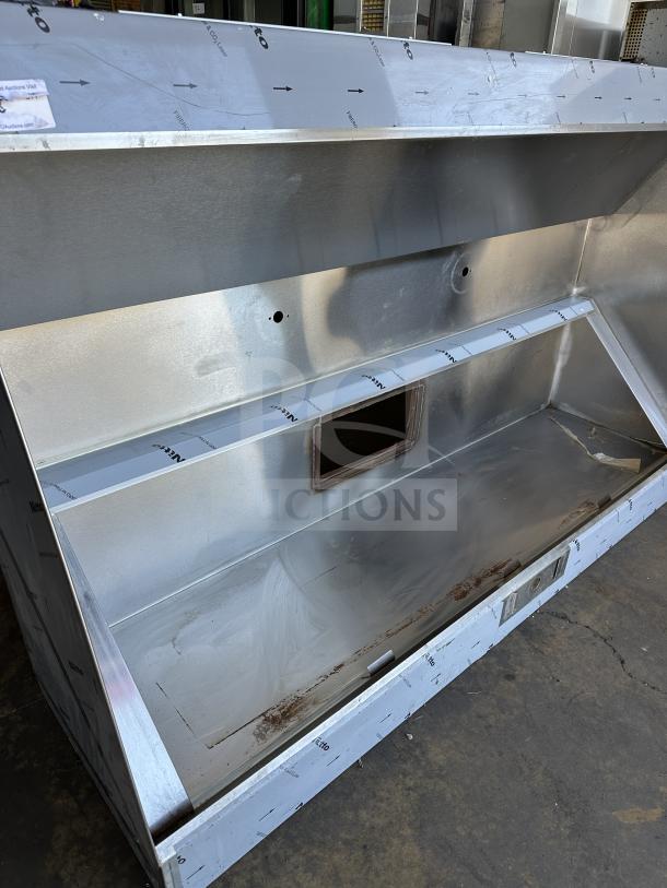 NEW Captive Air 72" stainless steel exhaust hood, pristine condition, for professional kitchens, visible mounting holes.